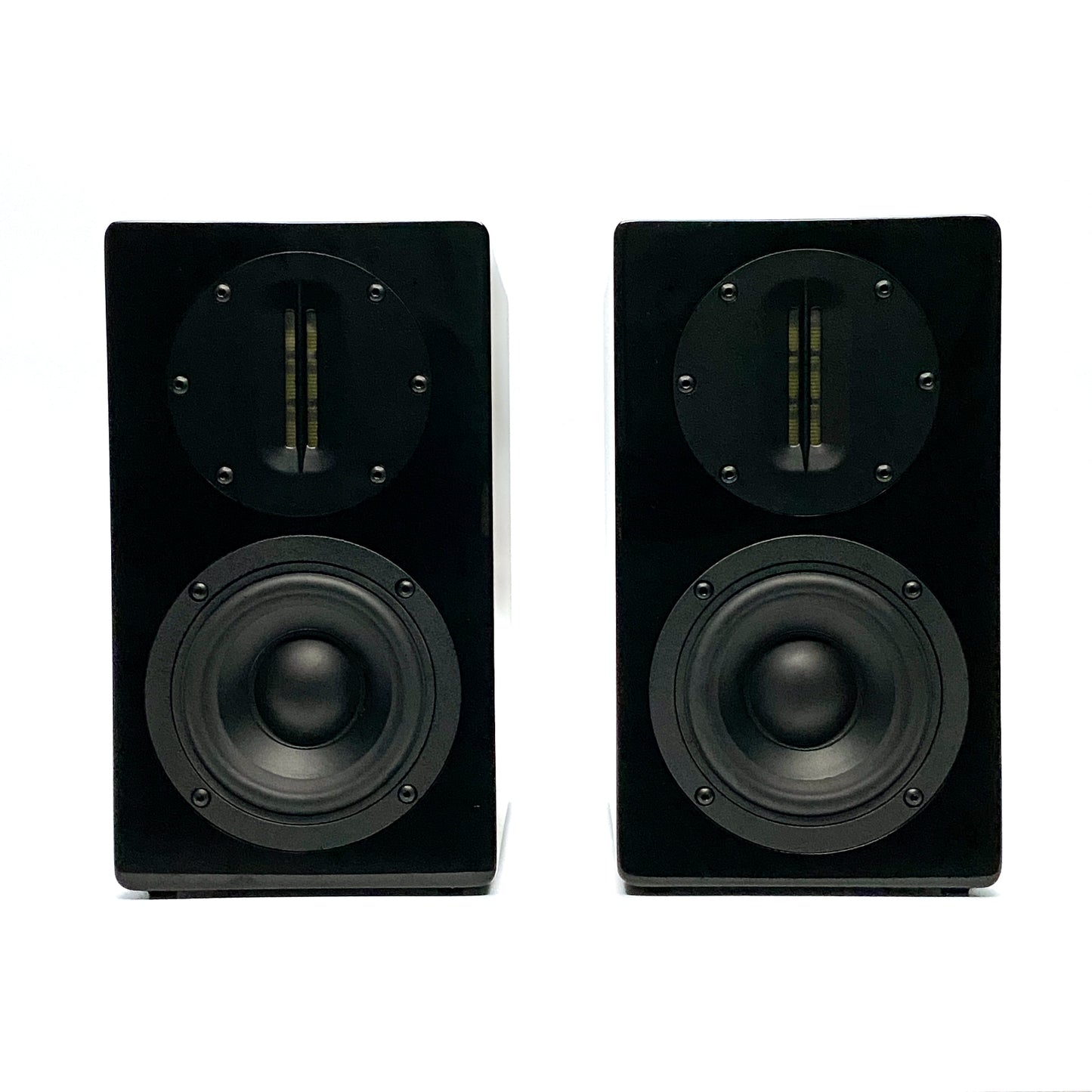 Official straight front studio view of a pair of Blue Aura AT700 compact bookshelf speakers in high-gloss piano black finish without their grilles.