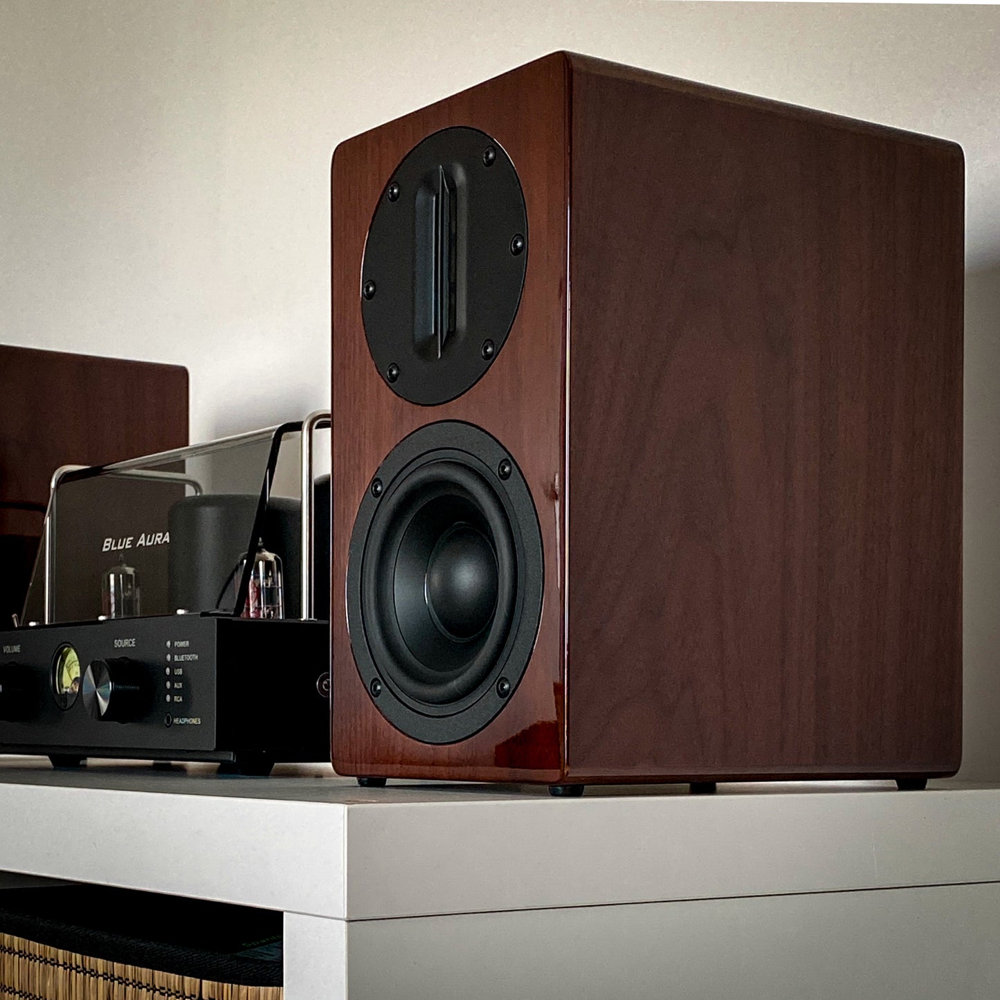 Side view of the Blue Aura AT700 speaker in walnut finish without front grille.