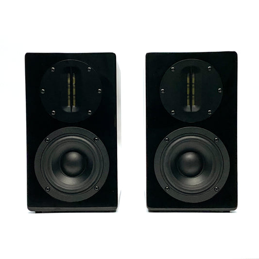 Official straight front studio view of a pair of Blue Aura AT700 compact bookshelf speakers in high-gloss piano black finish without their grilles.