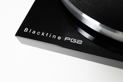 Macro close-up shot focusing on the elegant Blackline PG2 by Blue Aura branding printed on the corner of the glossy turntable plinth.
