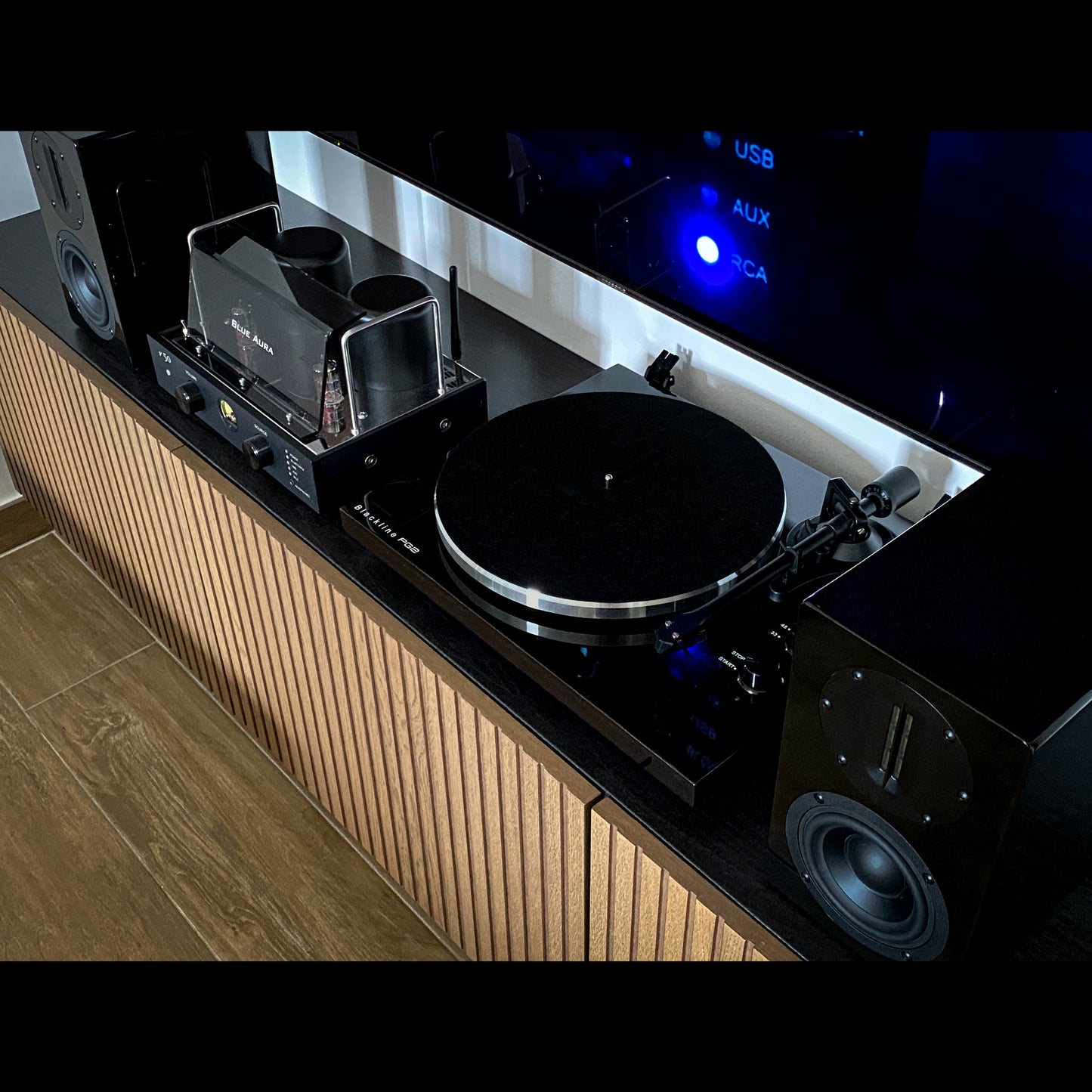 Top-down view of the complete Blue Aura Soul System Black Hi-Fi setup on a TV cabinet, showing the turntable without its clear dust cover.