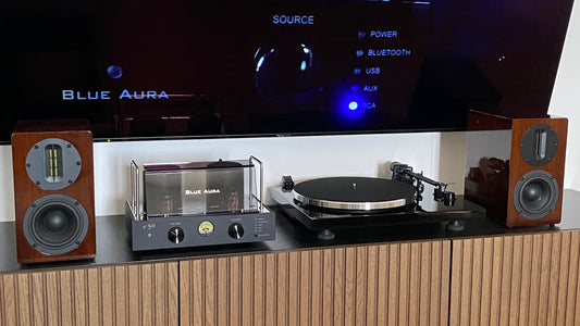 The Blue Aura Soul Prestige Hi-Fi system placed on the cabinet under the TV.