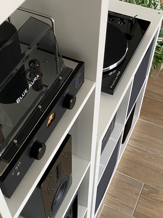 Close-up view of the Blue Aura v50 hybrid valve amplifier, angled to showcase the Blackline PG2 turntable logo on the cabinet.