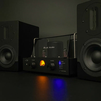Atmospheric night view of the Blue Aura stereo system with the v50 amplifier valves glowing in the dark.