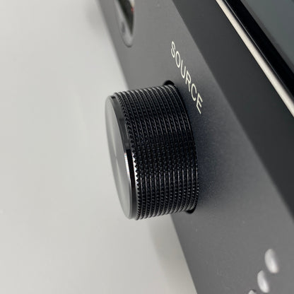 Official macro close-up view focusing on the knurled black aluminium source selector knob on the front panel of the Blue Aura v50 amplifier.