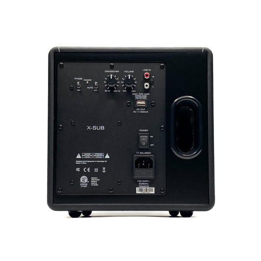 Straight rear studio view of the Blue Aura X-Sub active subwoofer, showcasing its backplate amplifier with crossover dials, volume control, phase switch, and RCA line inputs.