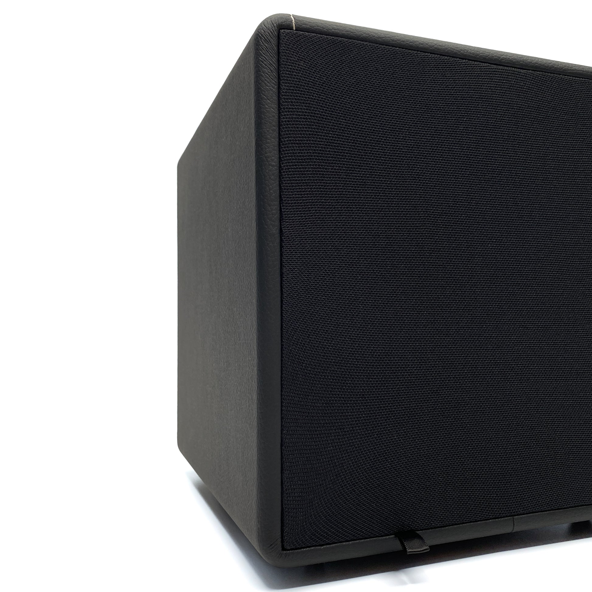 Official low-angle three-quarter studio shot of the Blue Aura X-Sub active subwoofer with its black fabric grille attached.